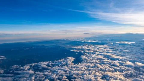 Aerial View Over Clouds During Sunset Flight Stock Photos