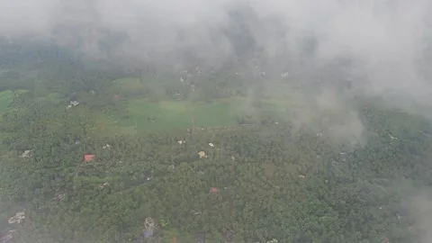 Aerial view- over the clouds the green earth 8k video Stock Footage 315031571