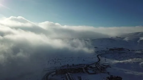 Aerial view over the clouds, mountain snow storm sun Stock Footage 144811228