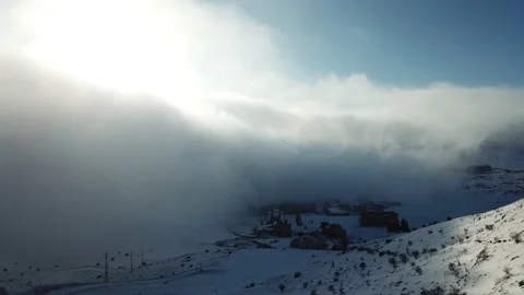 Aerial view over the clouds, mountain snow storm Stock Footage 144811408