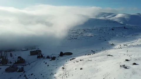 Aerial view over the clouds, mountain snow storm Stock Footage 144811484