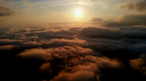 Aerial view: Over Clouds on Sun Rise in Mountains. Stock Photos