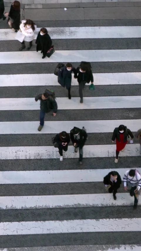 Aerial view over a crowd of pedestrian crossing street. Elevated view Stock Footage 318975861