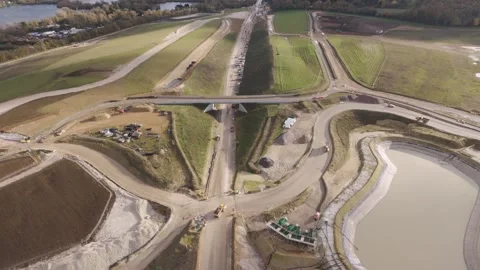 Aerial view over the development of the HS2 railway, highlighting its path Stock Footage 294182146