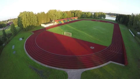 Aerial view over empty sport stadium in morning sunlight Stock-Footage 81381575