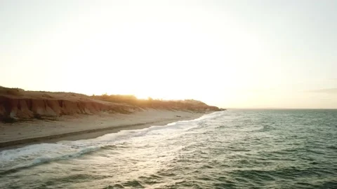 Aerial view in over exposed light by sunset of sand cliff in Canoa Quebrada B Stock Footage 146666485