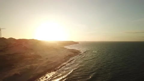 Aerial view in over exposed light by sunset of sand cliff in Canoa Quebrada B Stock Footage 146667031