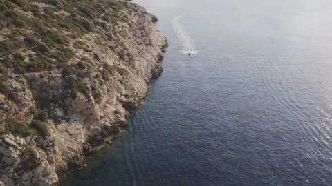 Aerial view over fast small tender next to cliffs at sunrise with INSPIRE 2 스톡 동영상 101564914