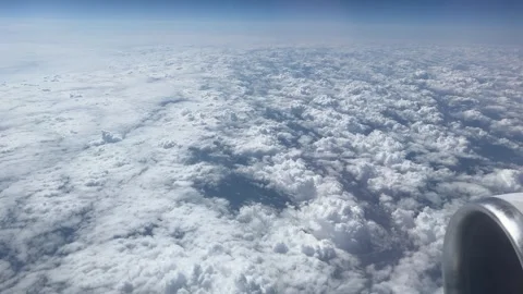 Aerial View Over Fluffy Clouds from Airplane Window 動画素材 341522376