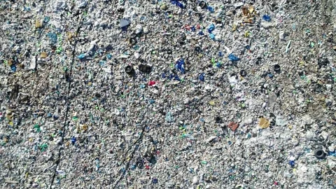 Aerial view over garbage city dump. Video stock 153130147