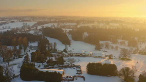 Aerial view over Golf Course with snow in Northern Ireland at sunset in 4K Stock Footage 151088821