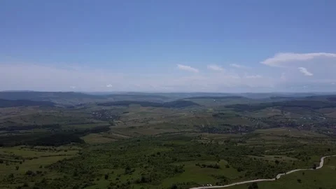 Aerial View Over Green Fields and Hills Stock Footage 156826793