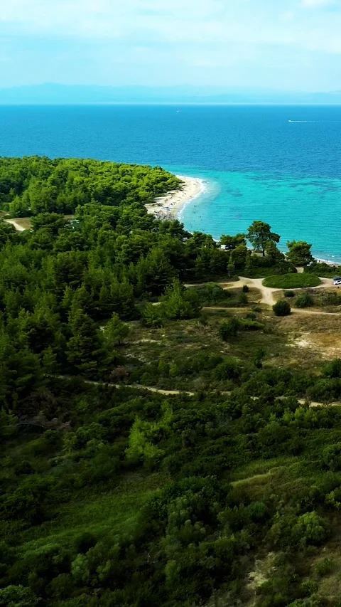 Aerial view over green forest shoreline and sea in Greece Stock Footage 342238664