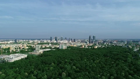 Aerial view over a green park in Warsaw, with the city centre behind 1 Stock Footage