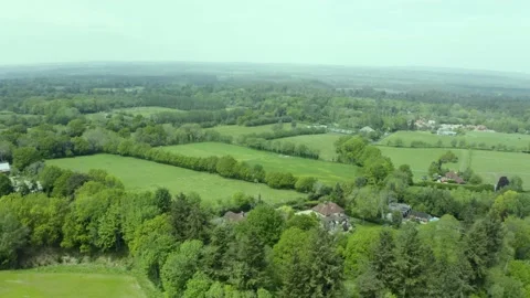 Aerial view over green patchwork farmland countryside pasture landscape Stock Footage 166249586