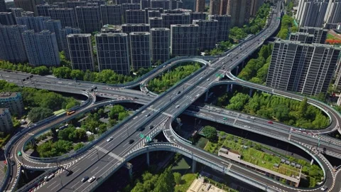 Aerial view over highway interchange and cityscape during the day. Hangzhou Stock Footage 314832479