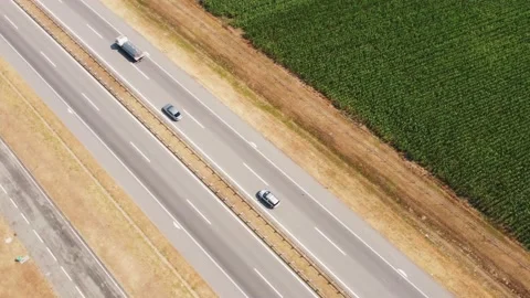 Aerial View Over a Highway with traffic In Beautiful Green Fields Stock Footage 157289342