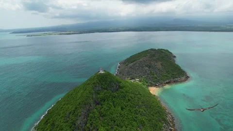 Aerial view over Ilheu das Cabras towards the lighthouse on the islet's summit Stock Footage 331756017