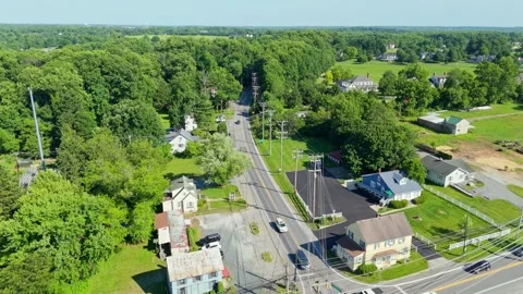 Aerial View Over Intersection and Tree‑Lined Horizon Stock Footage 336699155