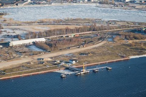 Aerial view over the island and industrial terminal on the river Stock Photos