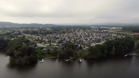 Aerial view over large lake in western Wisconsin to residential neighborhood. Stock Footage 166138348