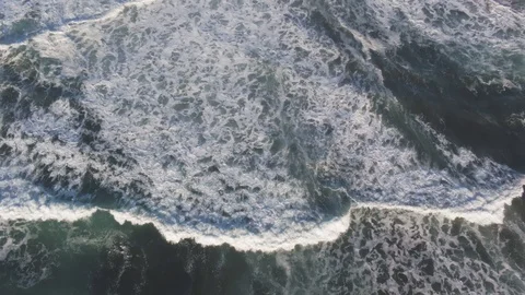 Aerial view over large surf waves at sunset hours Stock Footage 101718028
