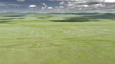 Aerial view over Mongolia steppe shows endless treeless plain - Empty Grassland Stock Footage 339723231