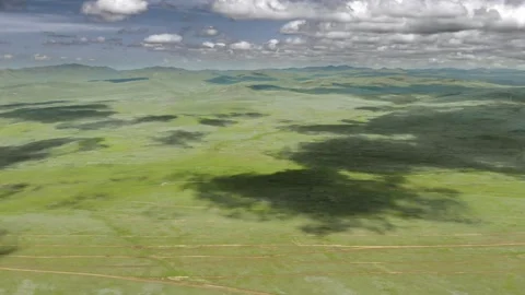 Aerial view over Mongolia steppe shows endless treeless plain - Rolling Meadow Stock Footage 339724068