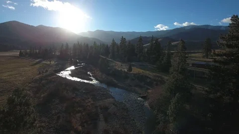 Aerial view over mountain river, forest and mountain at sunny autumn day Stock-Footage 82607600