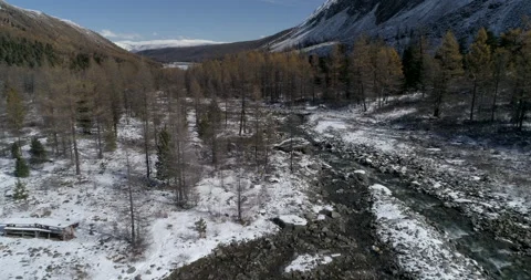 Aerial view over mountain stream in area of ​​glacier near mountain Aktru Stock Footage 143899029