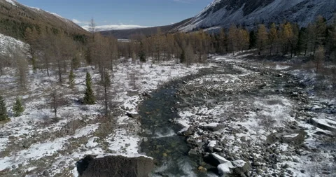 Aerial view over mountain stream in the area of ​​glacier near mountain Aktru Stock Footage 143899083
