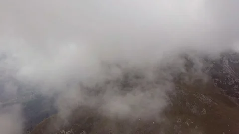 Aerial view over the mountains flying through clouds Video stock 80147133