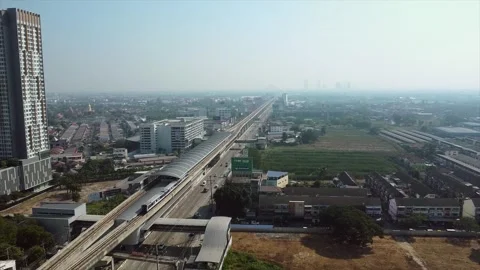 Aerial View Over A Moving Sky Train Over The Road In Nonthaburi, Thailand Stock Footage 262138652