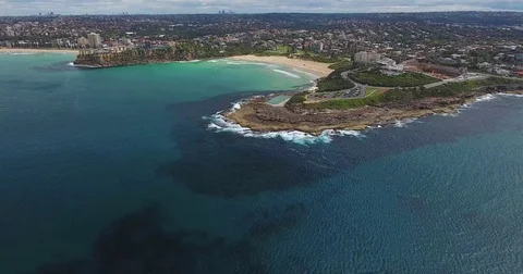 Aerial view over ocean beach and point with horizon line Stock Footage 70825231