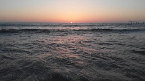 Aerial view over Ocean Beach at Sunset Stock Footage 88545667