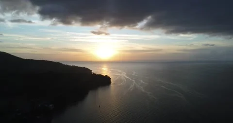 Aerial view over the ocean at sunset in the Philippines Stock Footage 163750204