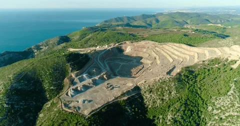Aerial view over an open pit mines and carry under the sunlight in Spain. There Stock Footage 146227361