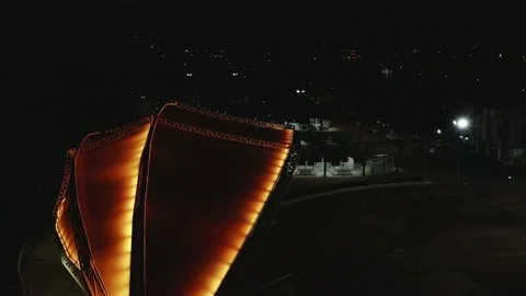 Aerial view over a open stage outdoors illuminated by red lights Stock Footage 146343548