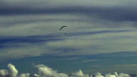 Aerial View over Paraglider Flying over Beautiful Cloudscape and Mountainscape Stock Footage 255370331