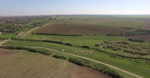 Aerial view over a plain field near a village Stock Footage 56024391