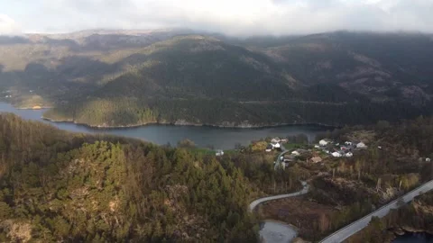 Aerial view over a remote Norwegian village situated on a fjord shore Video stock 335199224