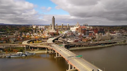 Aerial View Over River to Albany New York Downtown Skyline Highway Traffic Stock Footage 99861017