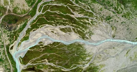 Aerial view over a river bed in the middle of a valley - drone view in 4K Stock Footage 137002650