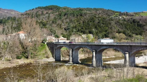 Aerial view over the river, nice french village and car drinving on a viaduct 動画素材 128159148