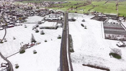 Aerial View Over River With Roads and Spring Transition From Snow to Green Видео 331588064