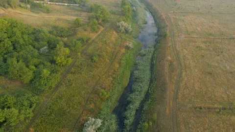 Aerial view over the river stream. Flying over the marshy area. Stock-Footage 92052328