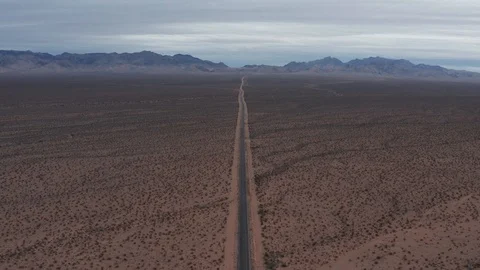 Aerial view over a road to nowhere in the desert Stock Footage 105550992