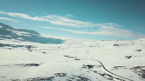 Aerial view over a road through a snow covered landscape Video stock 154832157