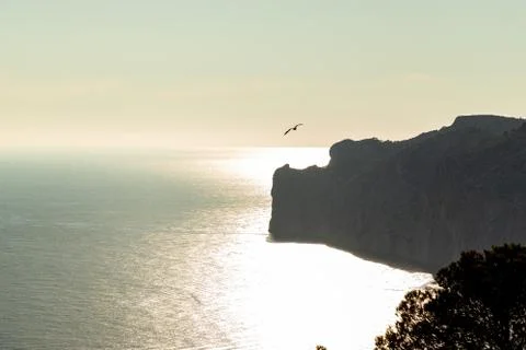 Aerial view over Rocks, cliffs, island and sea water during sunset from the v Foto stock