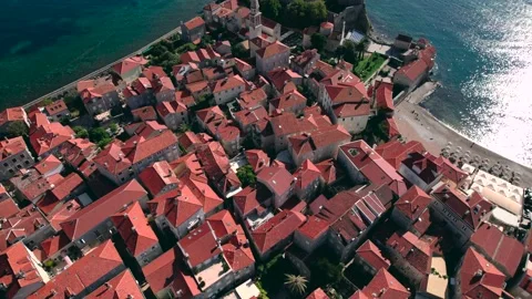 Aerial View over the roofs Of Budva Old Town Tower And Pier, Montenegro Video stock 230101448